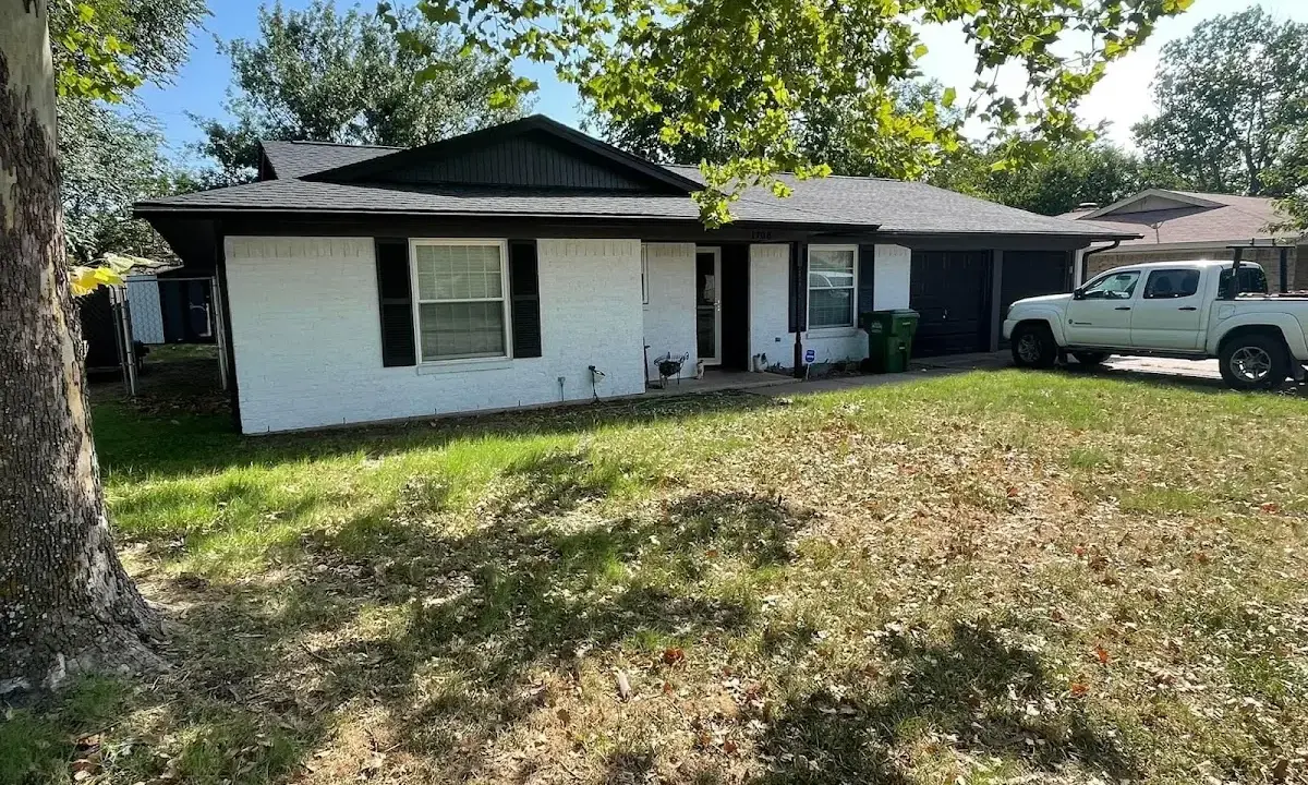 Professional roofing crew working on a residential roof in Amherst